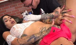 Nasty slut plays with regard to dildo during her tattoo session
